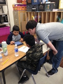 Senior Jeff Garza of Linda Mitten’s Early Childhood Workshop class helps third-graders at South Street Elementary School with their classwork. Garza, who also spent the day at the elementary school, shadowed teacher Luke Rosequist and his class. 