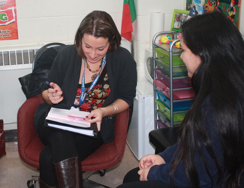 Senior Barbara Machado meets with ELL counselor Claudia DeMoura .