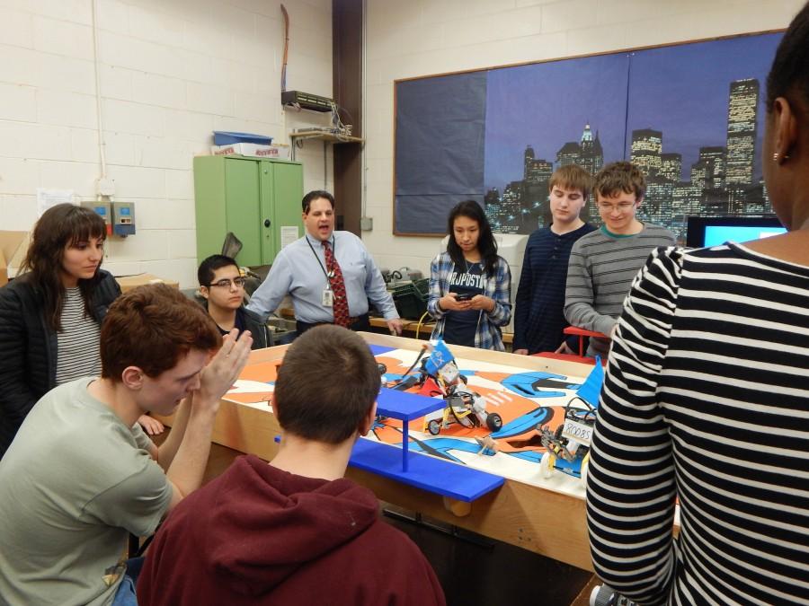 Eric Savoyski, adviser to the award-winning Robotics Club and instructor of Honors Robotics, works with students in preparation for upcoming competitions.