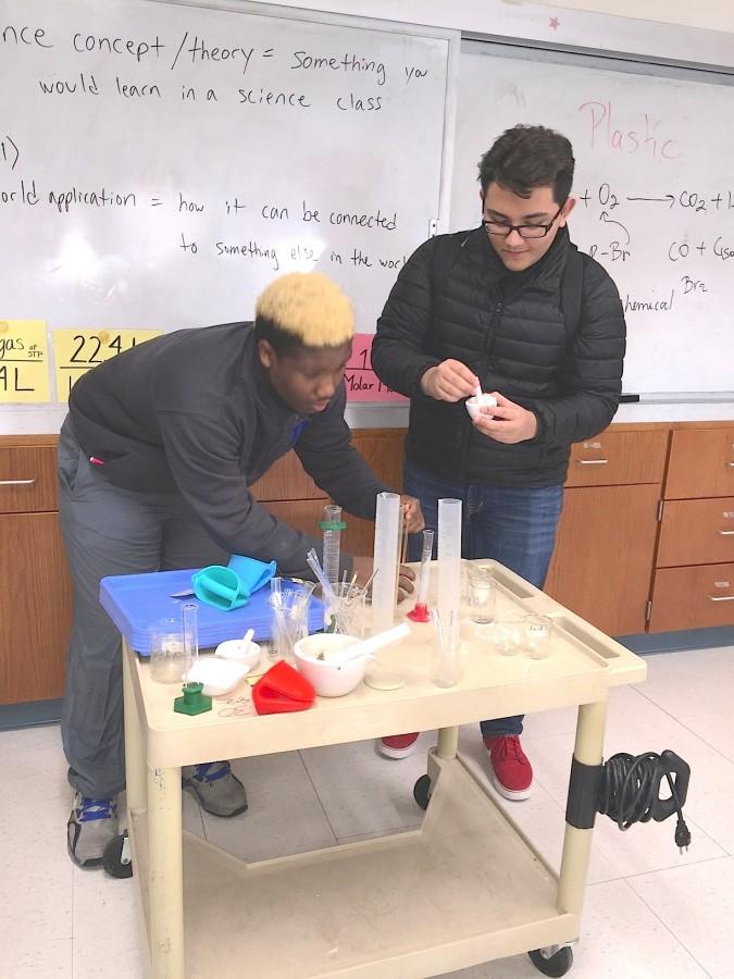 Solomon James, left, and Angel Romero collaborate on their Flint water crisis research.