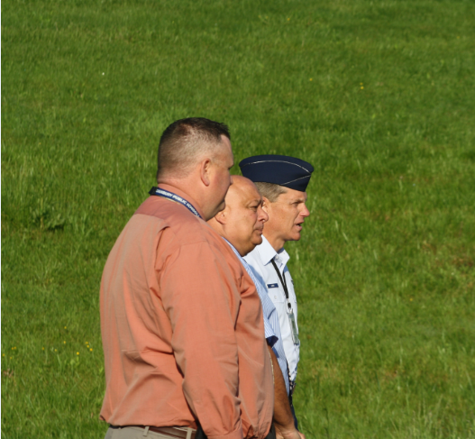 From left, Freshman Academy Principal Dan Donovan, Principal Gary Bocaccio and Lt. Col. John Lussi observe the AFJROTC units Memorial Day flag raising ceremony on Wednesday. Students, faculty and staff also observed the early-morning event.