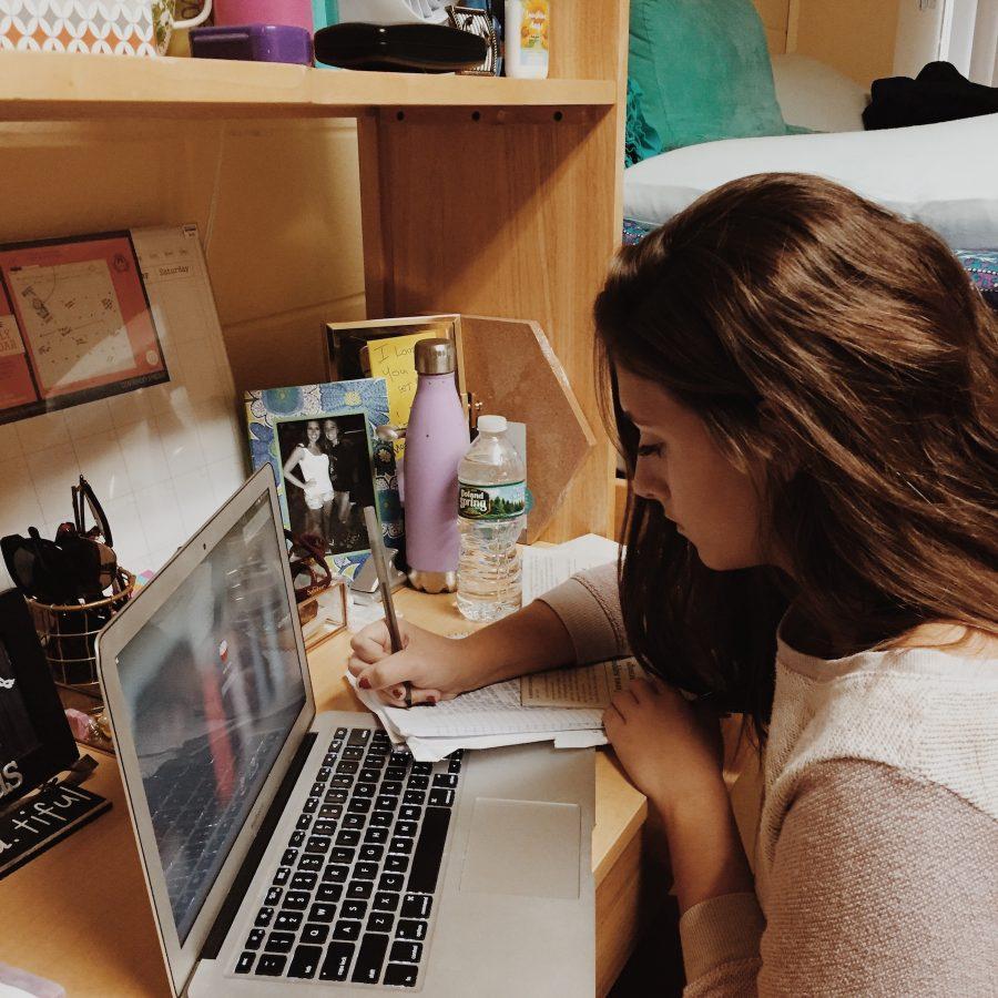 Caitlin Burke, class of 2016, works at her desk inside her dorm room at Salisbury University in Maryland.