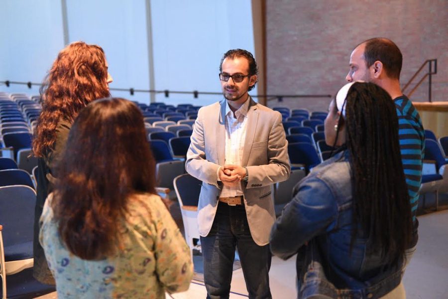 Syrian artist Mohamad Hafez speaks with members of the Social Studies Department during a presentation of his work at a recent professional development day event sponsored by the Art Department 