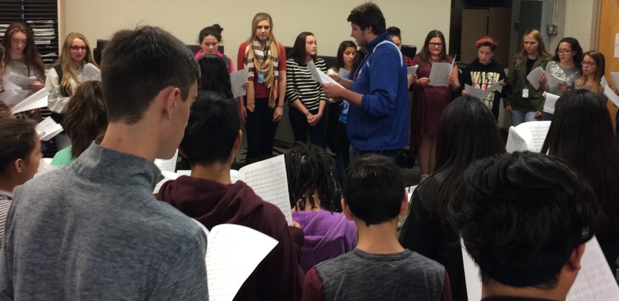 Madrigals member, senior Michael Gaboardi, conducts the Westside eighth-grade choir, along with the rest of the Madrigals, while singing Carol of the Bells.
