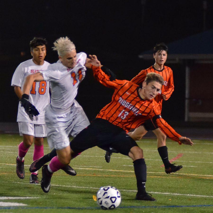Senior Kevin Spennato and a Ridgefield player fight for the ball during the Hatters senior night game.