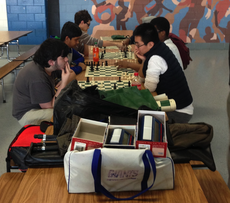 Members of this year chess team practice in the cafeteria. The team once again won the league traveling trophy.