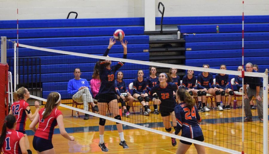 Mercer sets the volleyball for her team. 
