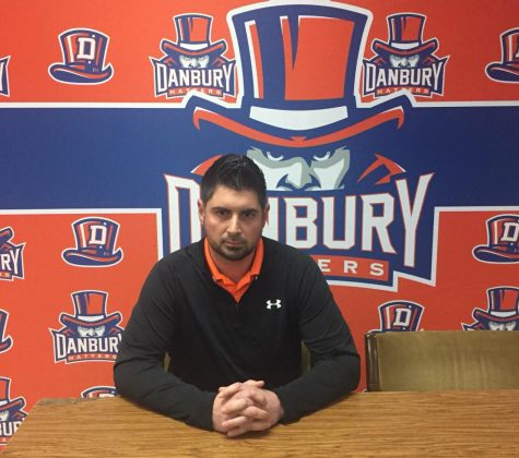 Coach Augustine Tieri sits in front of Danbury's new backdrop to meet with the press after it was announced today that he has been named head football coach.