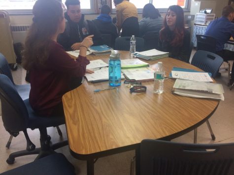 Casey Hanrahan works with a couple of her students