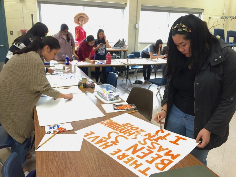 Students make posters for the Advocacy Initiative on March 14.