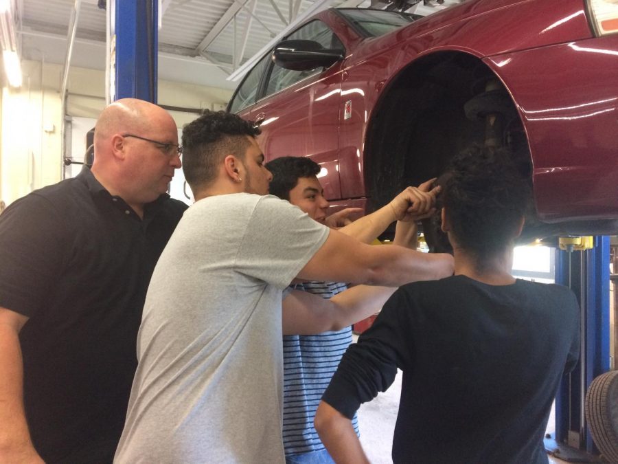 Sam Buck works with three of his students in the Auto Shop just days before leaving DHS and NEA-Danbury for a new union job in Syracuse, N.Y.