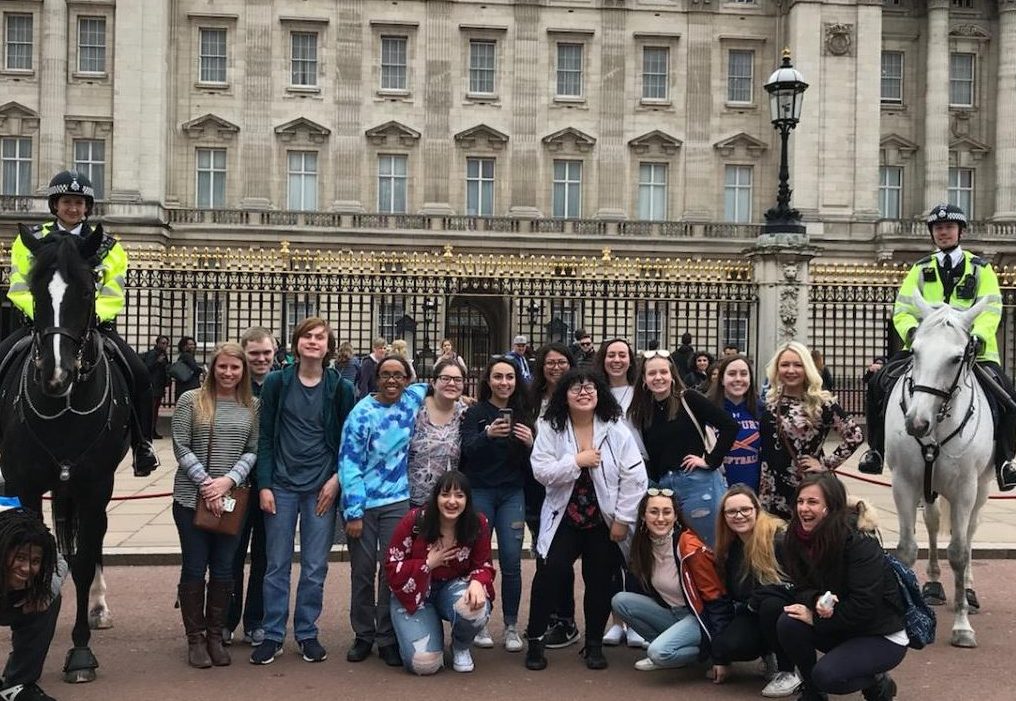 English teachers Arielle Fischer, left, and Danielle Costello, right, stand with their DHS charges in front of Buckingham Palace during the group's Spring Break trip to England.