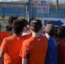 The boys tennis team huddles after a practice. The team this spring made it to the states.