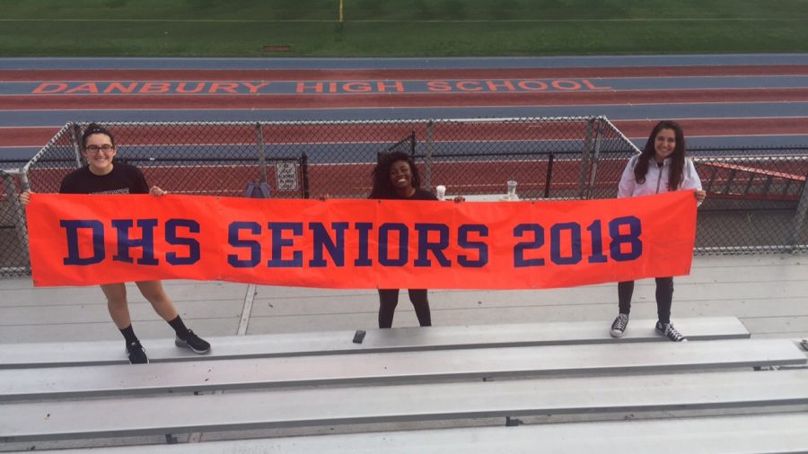 From left, Class of 2018 officers 
Treasurer Emily Grenier, President Naomi Thomas and Vice President Cristina Britton show off the class banner. They have planned a week of events for seniors. 