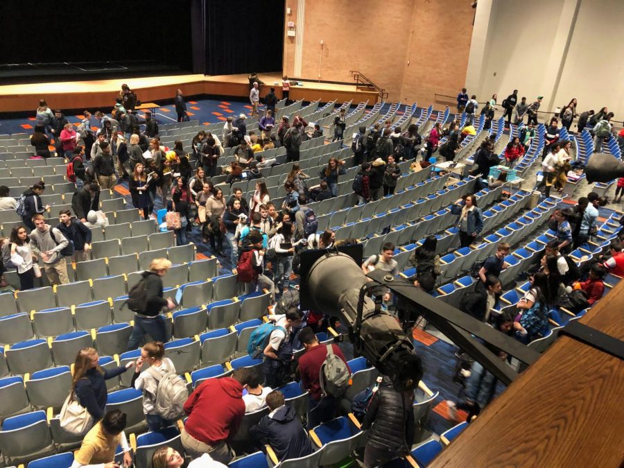 A balcony view of C3 and C4 classes convening today in the auditorium because of water damage in their classrooms caused by a ruptured pipe and malfunctioning sprinkler systems.