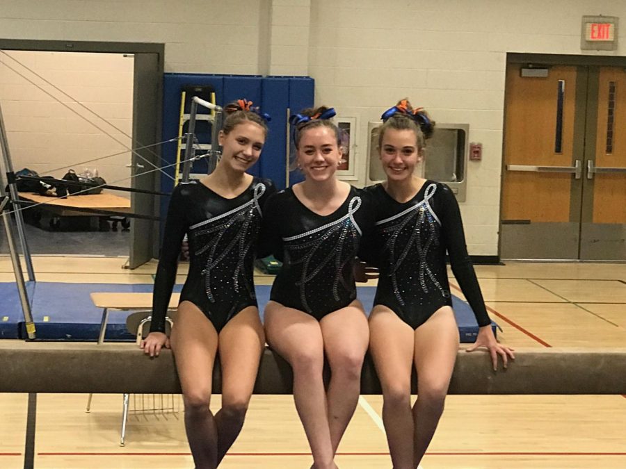 (Left to right) Grace Bennett, Bethany Palardy, and Paz Moran pose together in their gymnastics attire. 