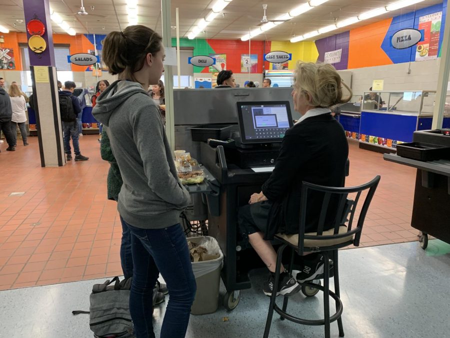 Jane Gawley, student, talks to cafeteria worker Chrissy Pisciotta while ordering lunch during wave four on January 16, 2019. Pisciotta works at the paying booth during lunch waves. 