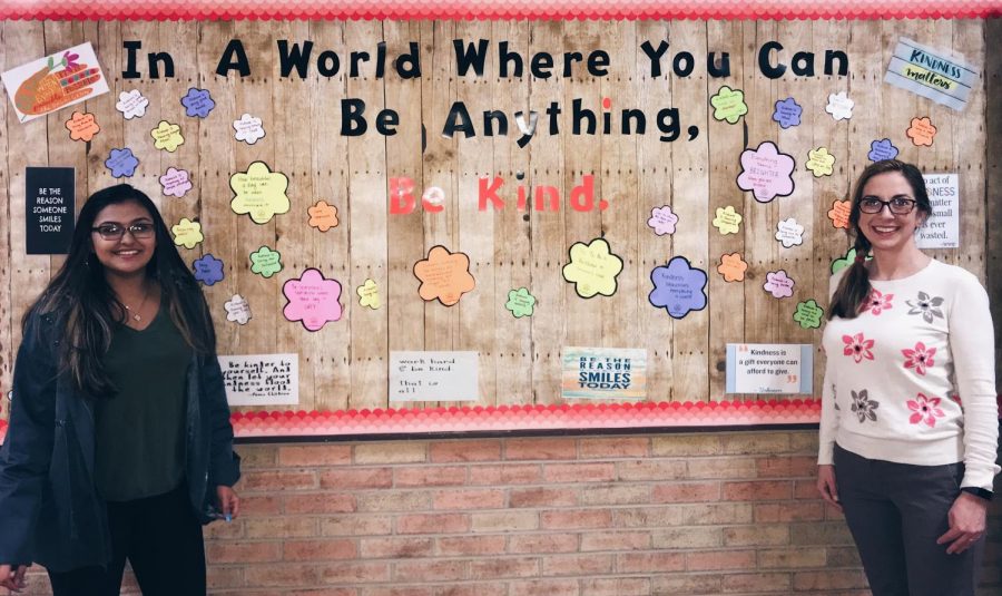 Media specialist Christie Taylor-Riendeau, right, puts up a kindness bulletin board outside of Library Learning Commons with the help of sophomore Juhi Taj and junior Veronica Guzman, not pictured.