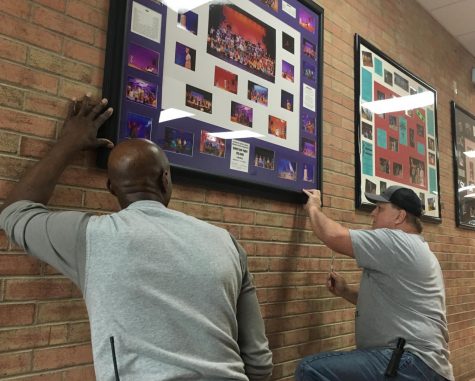 Billie Anderson, left, and Mike Morrison hang DHS  Productions collages of Once on this Island and In the Heights. This years musical, Godspell, opens April 4. 