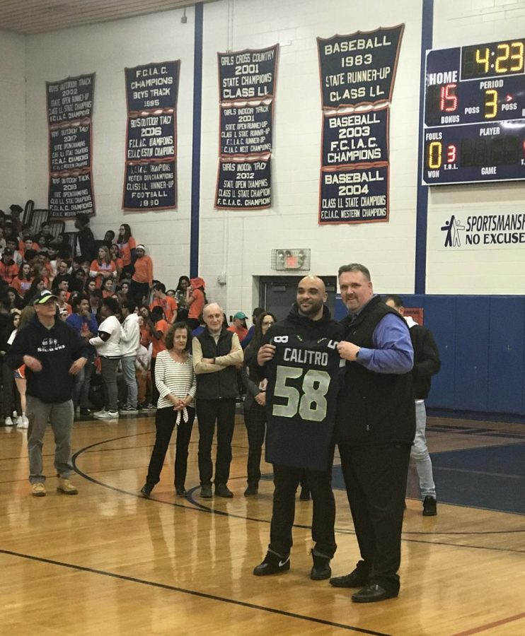 Austin Calitro stands with principal Dan Donovan during a half-time ceremony celebrating the Seattle Seahawk linebackers return to Danbury and his alma mater for a visit.