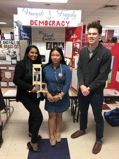 NSSHS students, from left, Rishita Bandaru, Lori Sigua and Shay Fashbender stand in front of their Connecticut History Day project on the topic of impactful revolutions. 