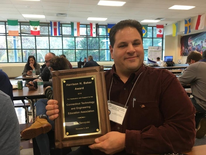 Savoyski poses with the Harrison H. Baker Award.