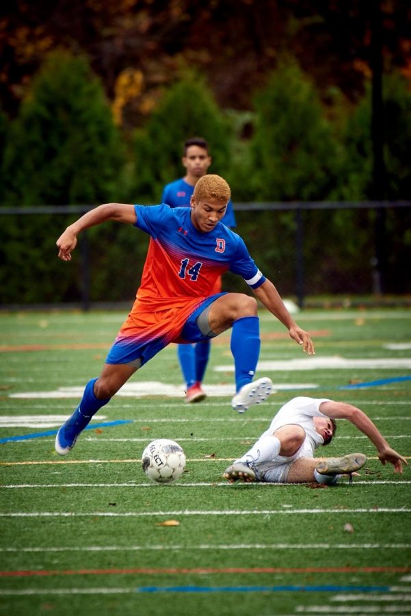 Tyler Warren dribbles the ball up the field in a game