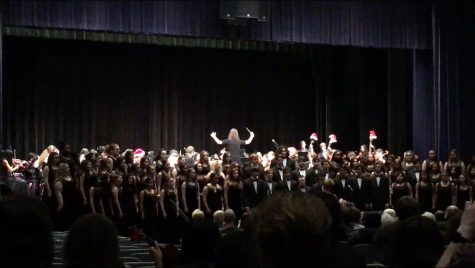 Mary Peters conducts the DHS Symphony Orchestra while Kimberly Russell conducts the DHS Choir in a joint song at the 2019 DHS Winter Concert. The concert also featured the DHS Band.