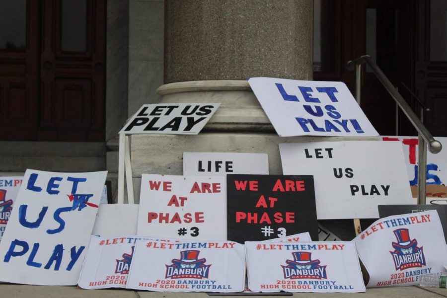 The DHS football team pleads to the CIAC to let us play through creative signs at the Sept. 9 protest.