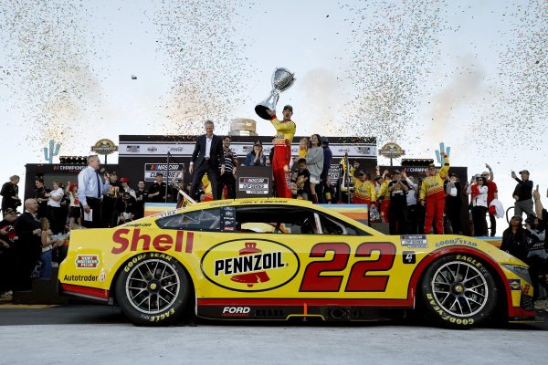 Joey Logano celebrates NASCAR Cup Series Championship trophy in victory lane after winning the NASCAR Cup Series Championship 