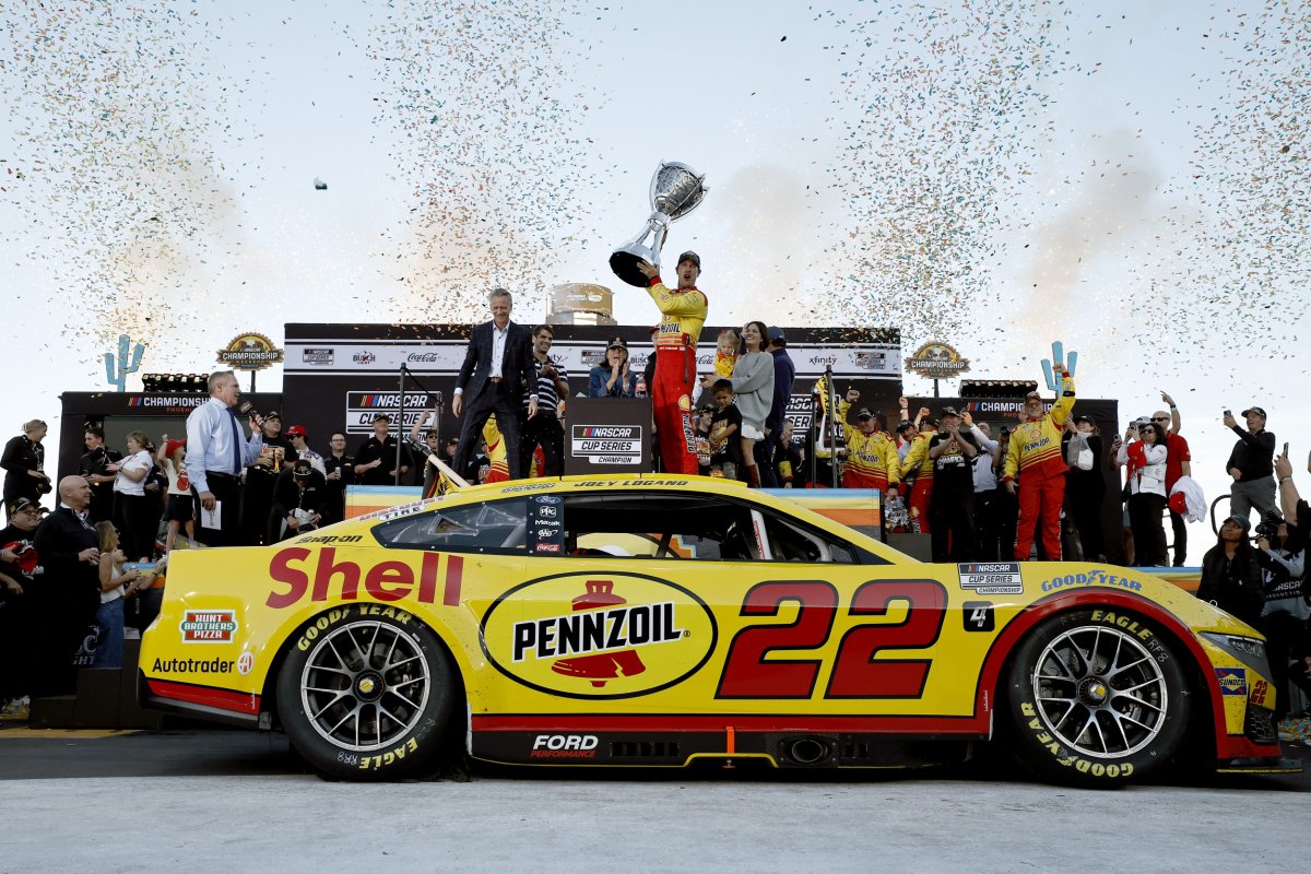 Joey Logano celebrates NASCAR Cup Series Championship trophy in victory lane after winning the NASCAR Cup Series Championship 