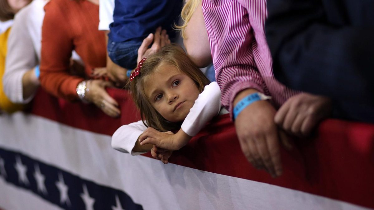 A young girl looks on during a campaign rally for Romney at Avon Lake High School on Monday.