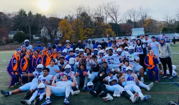 DHS Football team and Varsity Cheer squad celebrating the win against Westhill